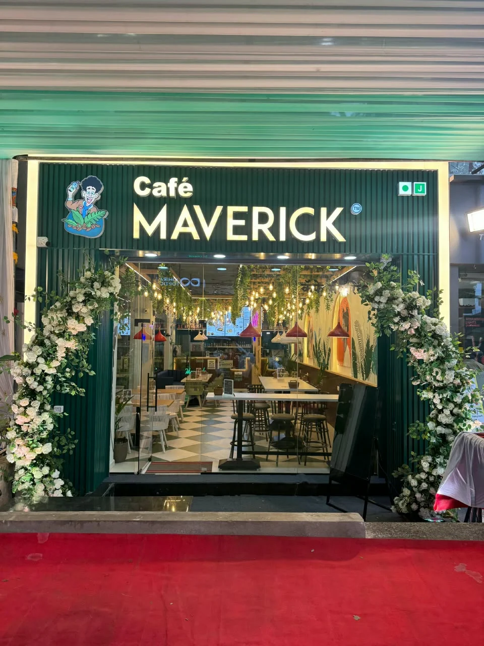 Café Maverick interior with hanging plants and ambient lighting
